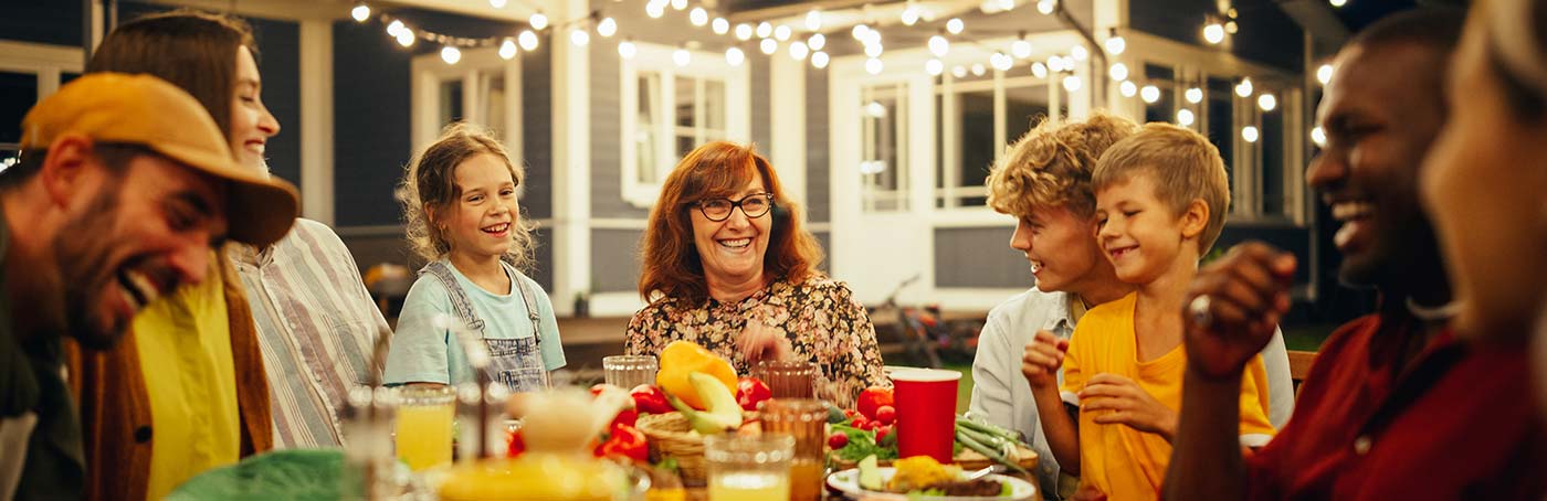 group of people laughing over a meal