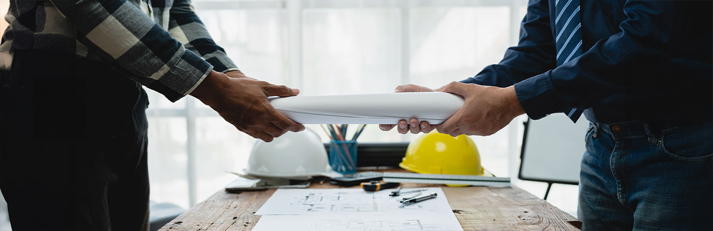 construction workers exchanging a blueprint